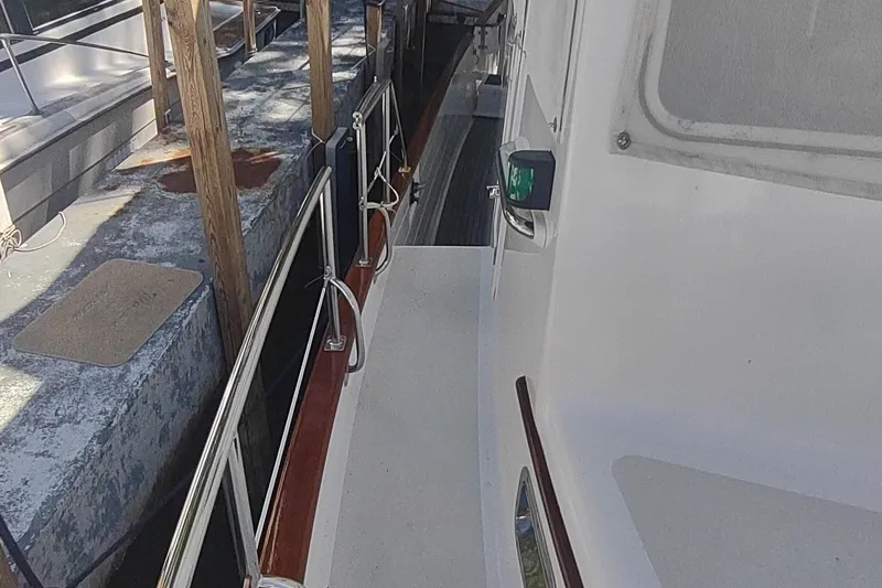 Slide: The Image of Side view of 2001 Kadey-Krogen 39 yacht docked at marina. - 10