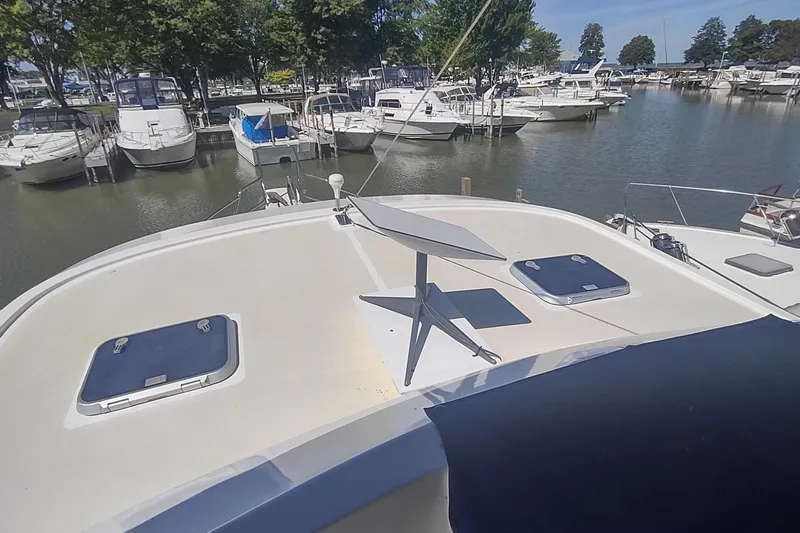 Slide: The Image of Kadey-Krogen 39 yacht (2001) docked, featuring a satellite dish on the deck. - 13