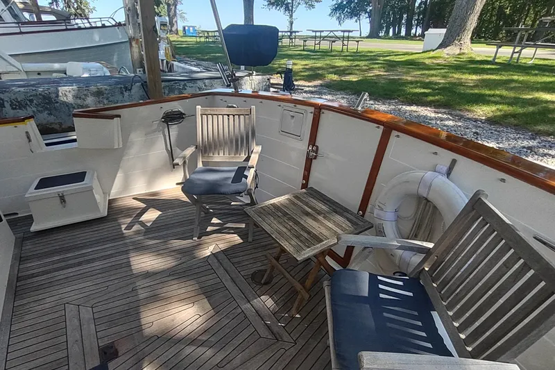 Slide: The Image of Cozy outdoor seating on 2001 Kadey-Krogen 39 boat with wooden deck and chairs. - 17