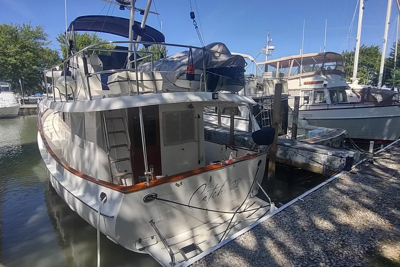 Slide: The Image of 2001 Kadey-Krogen 39 yacht docked at marina, surrounded by other boats. - 18