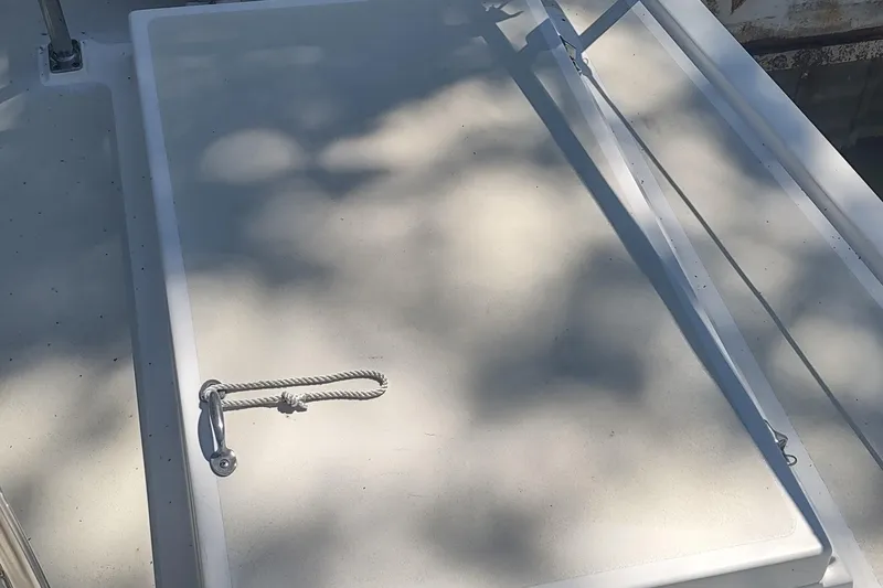 Slide: The Image of Hatch on 2001 Kadey-Krogen 39 boat, featuring a rope handle and shadow patterns. - 23