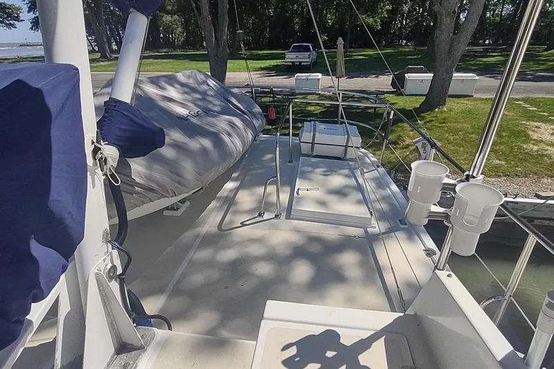 Slide: The Image of Deck view of 2001 Kadey-Krogen 39 yacht with covered equipment and scenic background. - 24