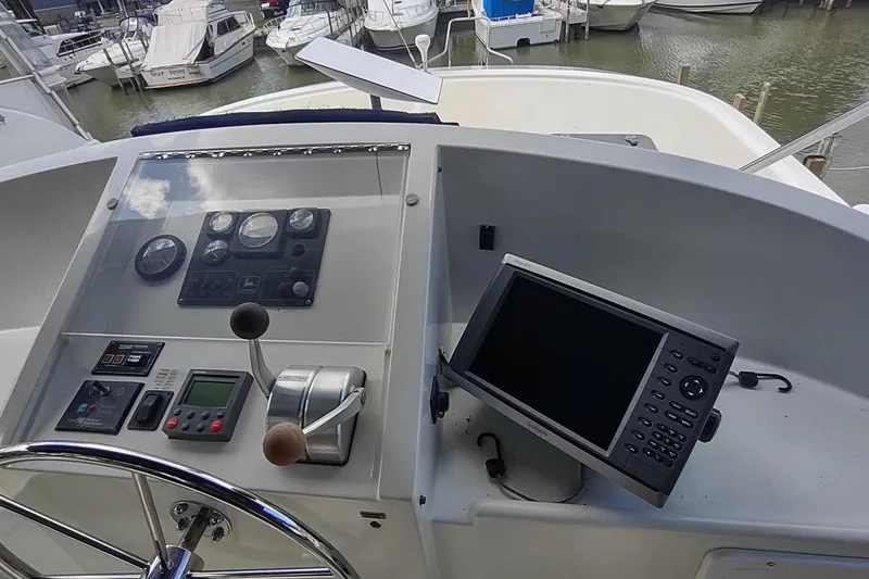 Slide: The Image of Helm of 2001 Kadey-Krogen 39 yacht with navigation equipment and controls. - 25
