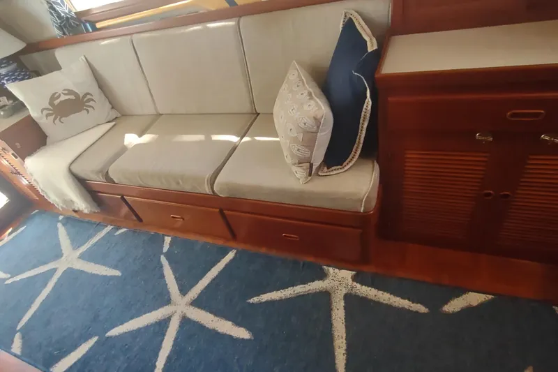Slide: The Image of Cozy seating area on 2001 Kadey-Krogen 39 with nautical-themed decor and starfish rug. - 31