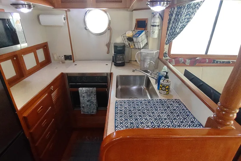Slide: The Image of Compact kitchen in 2001 Kadey-Krogen 39 yacht with sink, stove, and storage. - 35