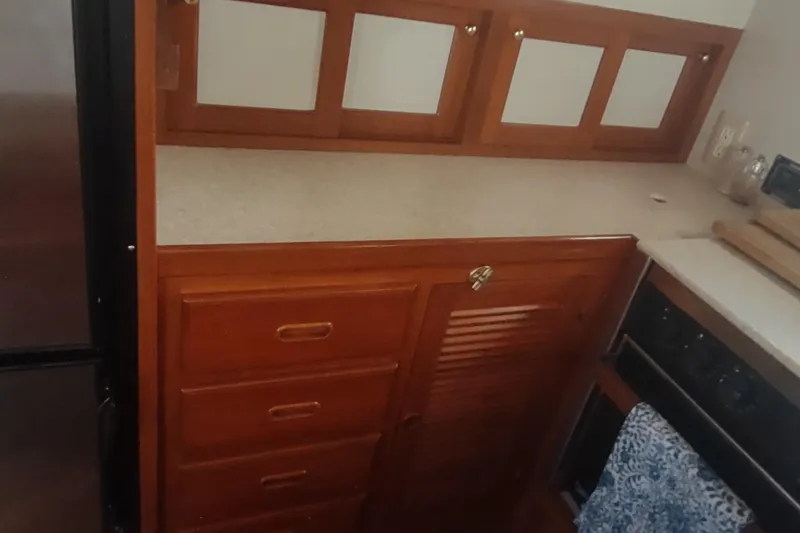 Slide: The Image of Wooden cabinetry in the galley of a 2001 Kadey-Krogen 39 yacht. - 36