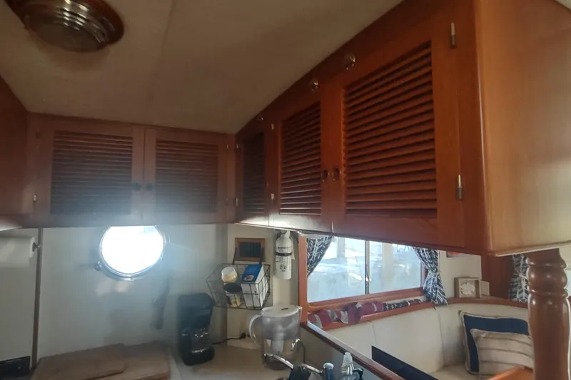 Slide: The Image of Interior of 2001 Kadey-Krogen 39 boat with wooden cabinets and cozy seating area. - 37