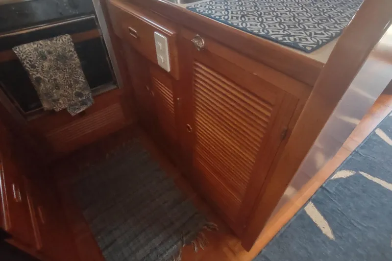 Slide: The Image of Wooden interior of 2001 Kadey-Krogen 39 yacht with cabinets and patterned rugs. - 38