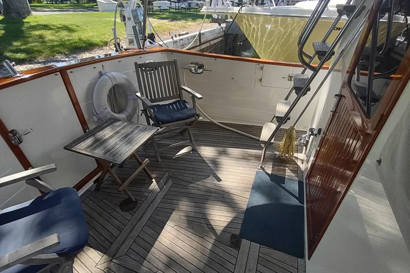 Slide: The Image of 2001 Kadey-Krogen 39 yacht deck with chairs, table, and life preserver. - 4