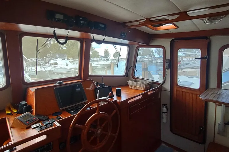 Slide: The Image of Interior view of 2001 Kadey-Krogen 39 boat helm with wooden steering wheel. - 44