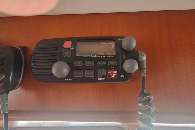 Slide: The Image of Marine radio equipment on 2001 Kadey-Krogen 39 boat, mounted on wooden panel. - 51