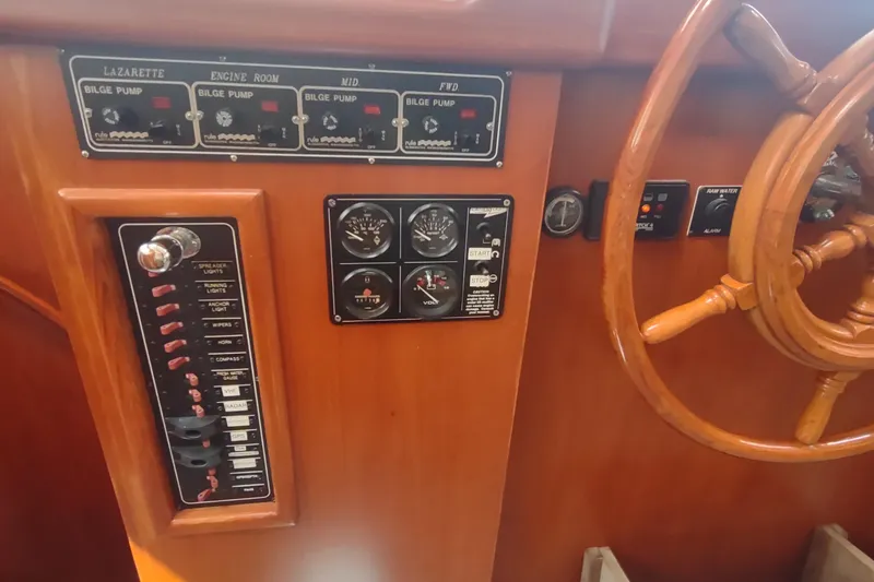Slide: The Image of Control panel of a 2001 Kadey-Krogen 39 boat with wooden steering wheel. - 53