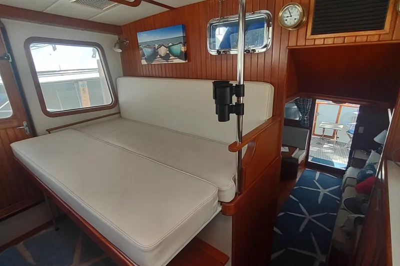 Slide: The Image of Interior of 2001 Kadey-Krogen 39 yacht with cozy seating and nautical decor. - 57
