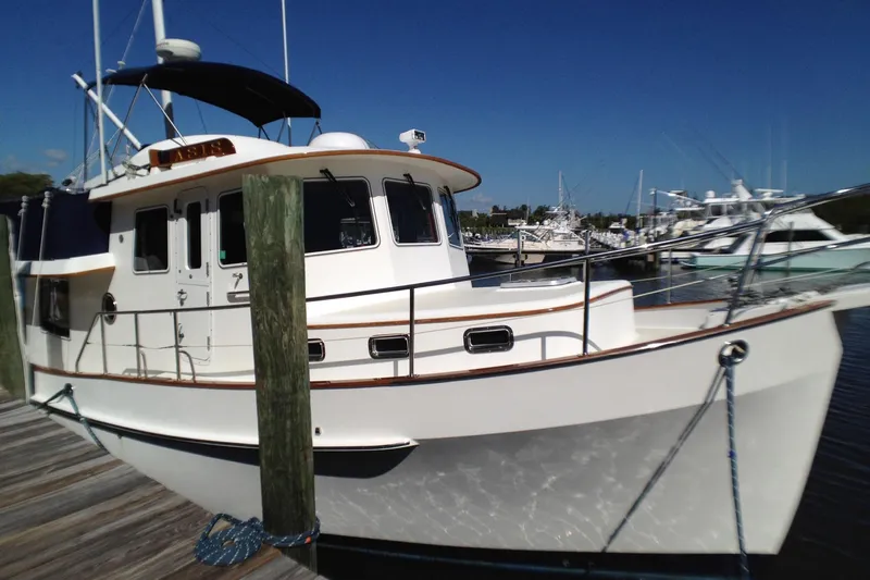 Slide: The Image of 2001 Kadey-Krogen 39 yacht docked at marina under clear blue sky. - 6