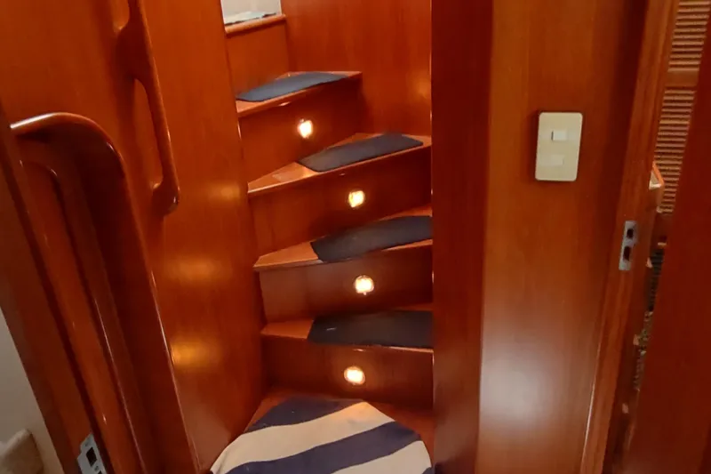 Slide: The Image of Wooden staircase with blue carpet and lights on a 2001 Kadey-Krogen 39 yacht. - 61
