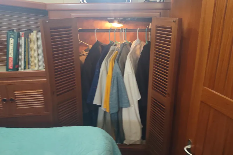 Slide: The Image of Wooden closet with clothes hanging inside, Kadey-Krogen 39 yacht interior, 2001 model. - 66
