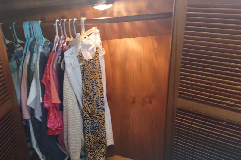 Slide: The Image of Wooden closet with clothes hanging, illuminated interior, Kadey-Krogen 39, 2001 model. - 67