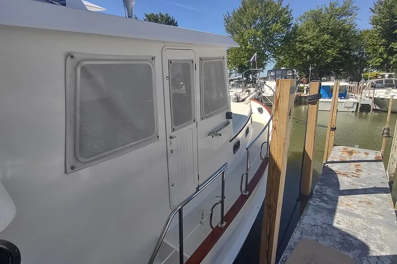 Slide: The Image of 2001 Kadey-Krogen 39 yacht docked at a marina with clear skies. - 7