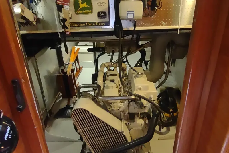 Slide: The Image of Engine room of a 2001 Kadey-Krogen 39 boat with visible machinery and tools. - 70