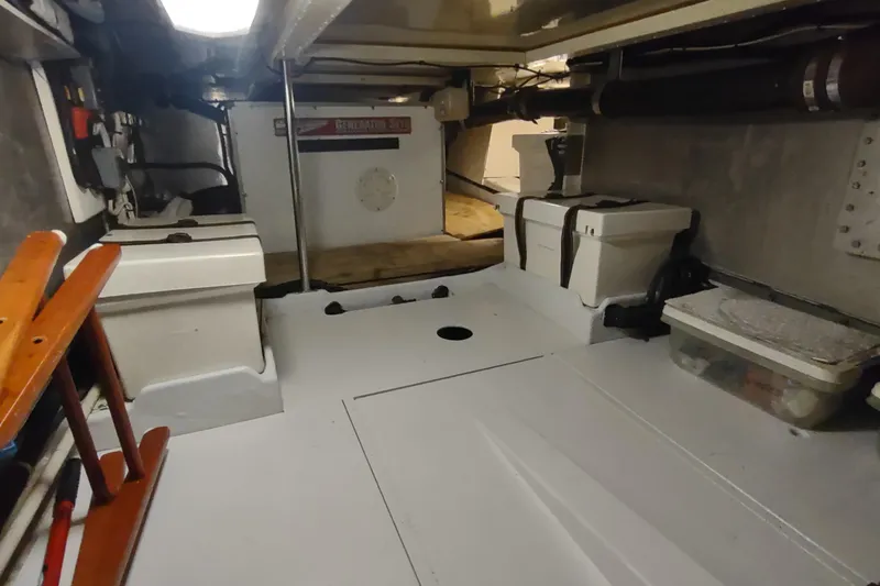 Slide: The Image of Engine room of a 2001 Kadey-Krogen 39 boat, featuring equipment and storage. - 71