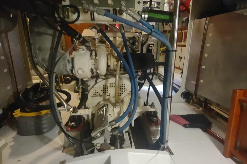 Slide: The Image of Engine room of a 2001 Kadey-Krogen 39 boat, showcasing mechanical components and wiring. - 72