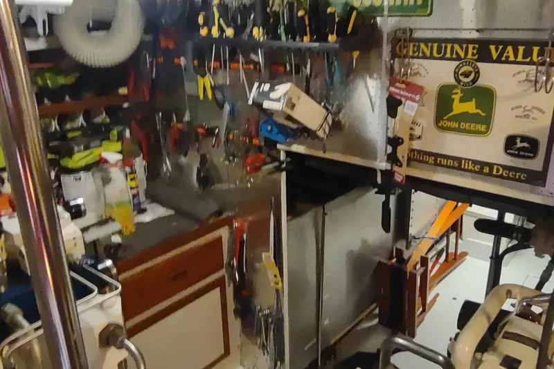 Slide: The Image of Workshop area on a 2001 Kadey-Krogen 39 boat, featuring tools and John Deere signage. - 73