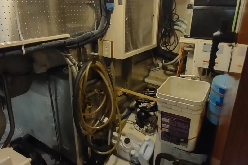 Slide: The Image of Engine room of a 2001 Kadey-Krogen 39 boat with various equipment and tools. - 75