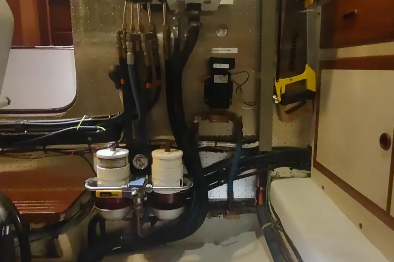 Slide: The Image of Engine room of a 2001 Kadey-Krogen 39 boat with fuel filters and hoses. - 77