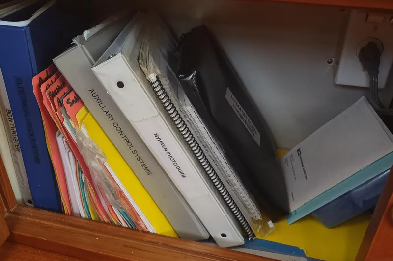 Slide: The Image of Manuals and binders for Kadey-Krogen 39, 2001, including auxiliary control systems and electrical deck systems. - 87