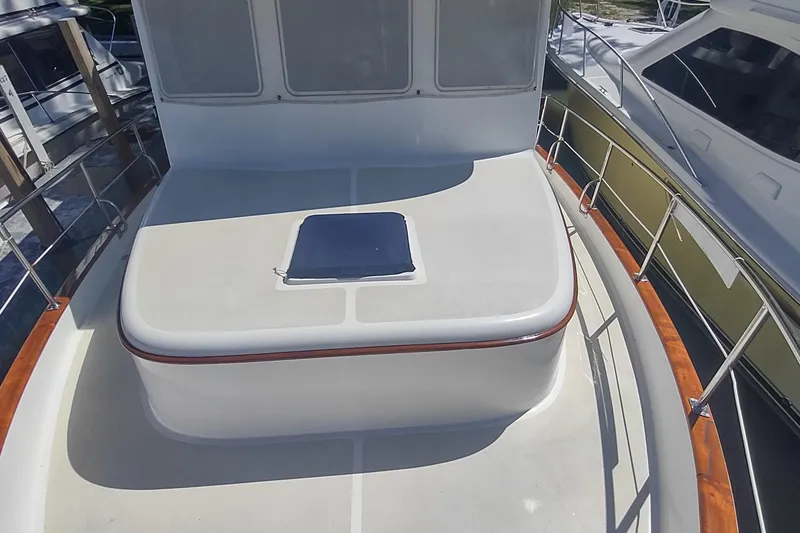 Slide: The Image of 2001 Kadey-Krogen 39 yacht deck with hatch, featuring sleek design and wooden railings. - 9