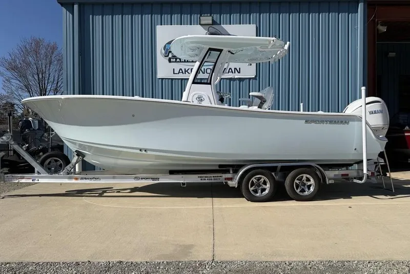 The Image of 2026 Sportsman Open 232 Center Console boat on trailer outside dealership. - 0