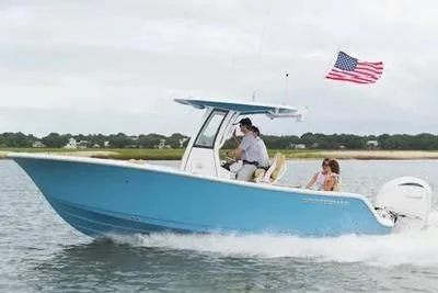 The Image of 2026 Sportsman Open 232 boat cruising with American flag on water. - 1
