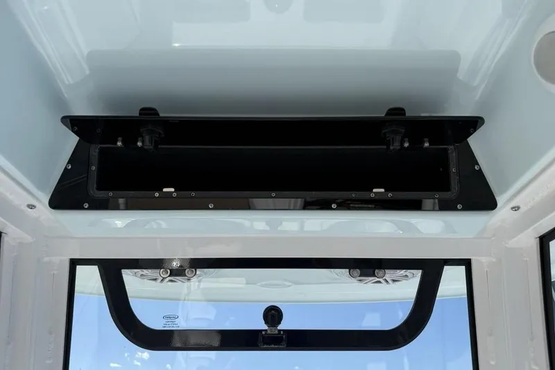 Slide: The Image of 2026 Sportsman Open 232 Center Console interior view, featuring overhead storage compartment. - 17