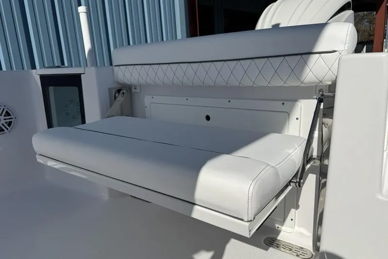 Slide: The Image of 2026 Sportsman Open 232 Center Console boat with white cushioned seating. - 18