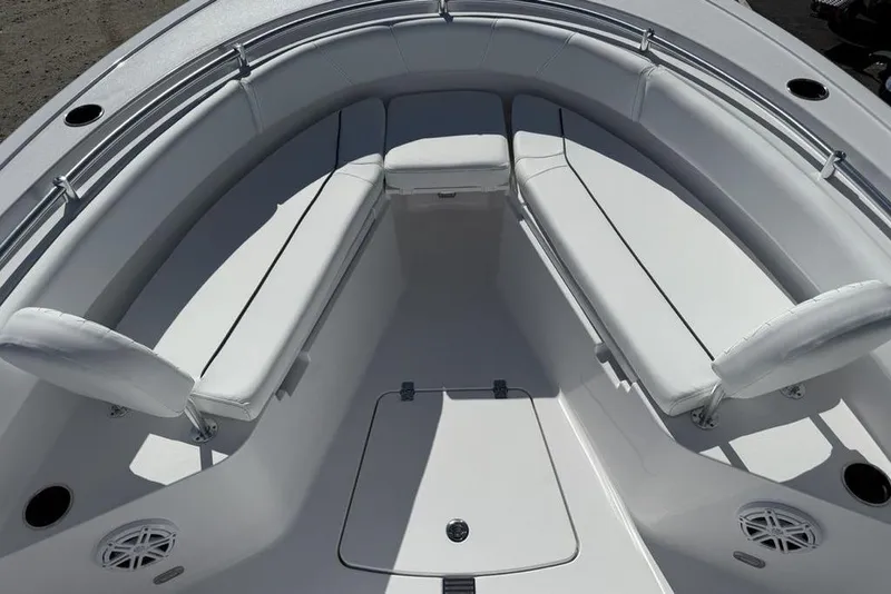 Slide: The Image of 2026 Sportsman Open 232 Center Console boat interior with white cushioned seating. - 26