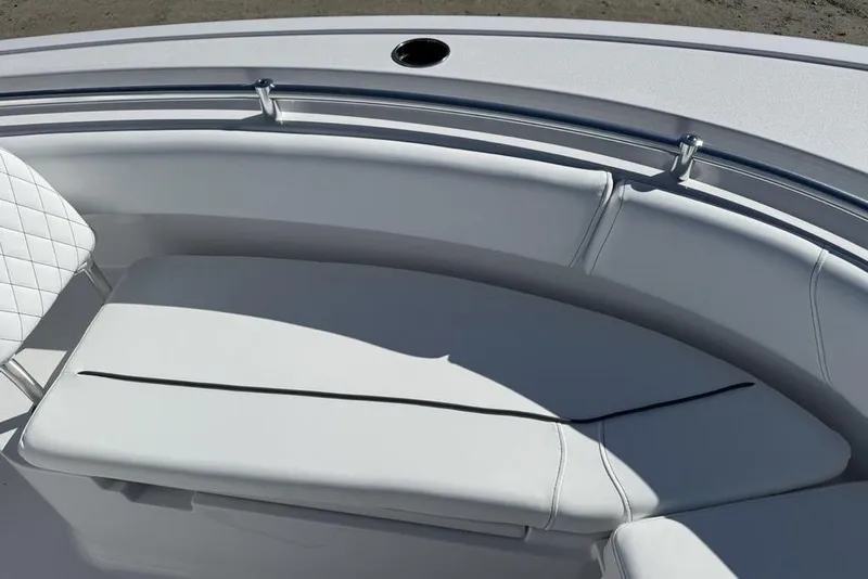 Slide: The Image of 2026 Sportsman Open 232 Center Console boat with cushioned seating and stainless steel railing. - 28