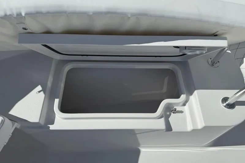 Slide: The Image of 2026 Sportsman Open 232 Center Console storage compartment, open lid, white interior. - 3
