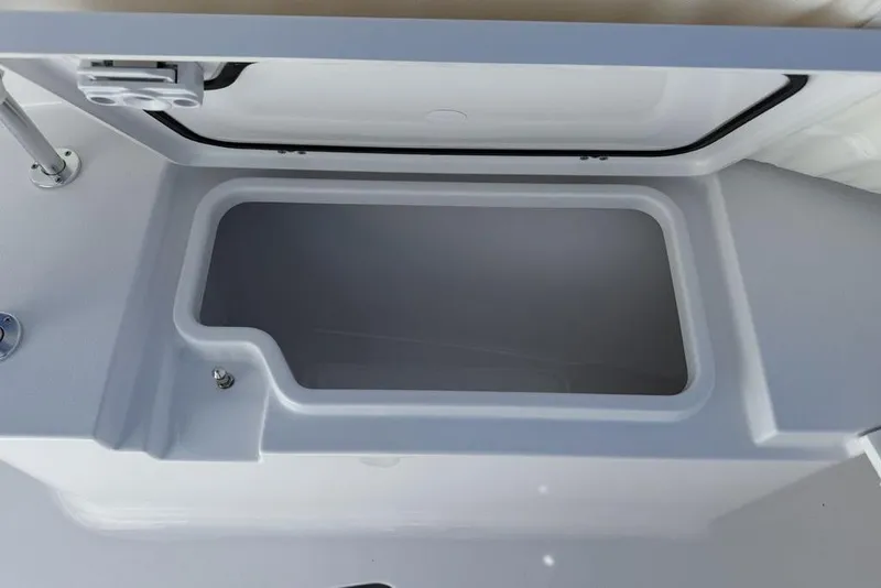 Slide: The Image of 2026 Sportsman Open 232 Center Console storage compartment, open lid view. - 31