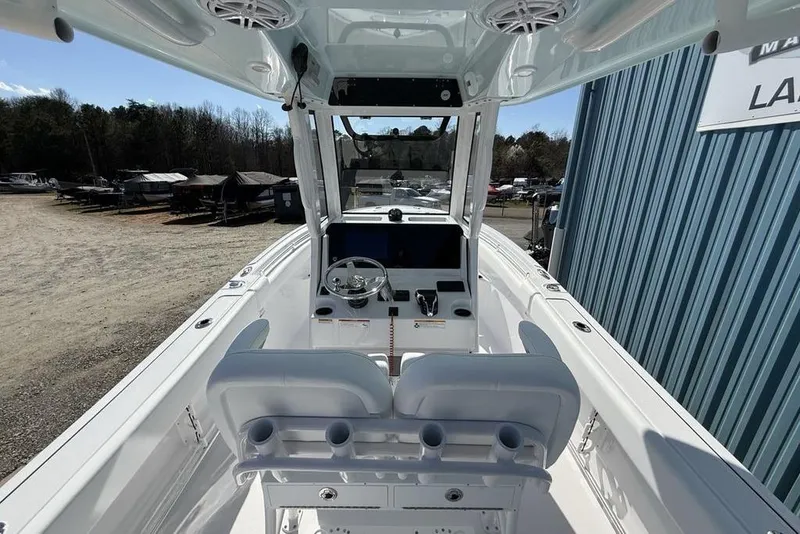 Slide: The Image of 2026 Sportsman Open 232 Center Console boat interior with steering wheel and seating. - 36
