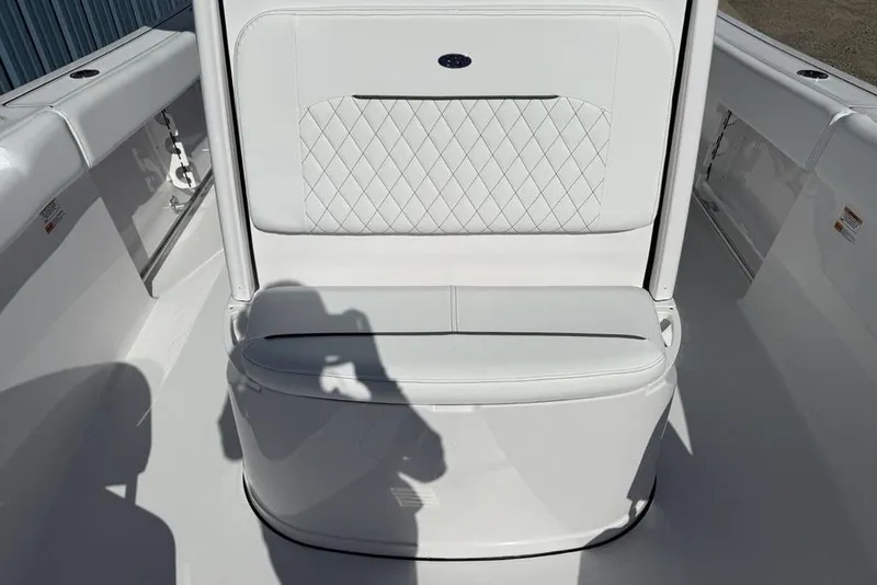 Slide: The Image of 2026 Sportsman Open 232 Center Console boat interior with white cushioned seating. - 8