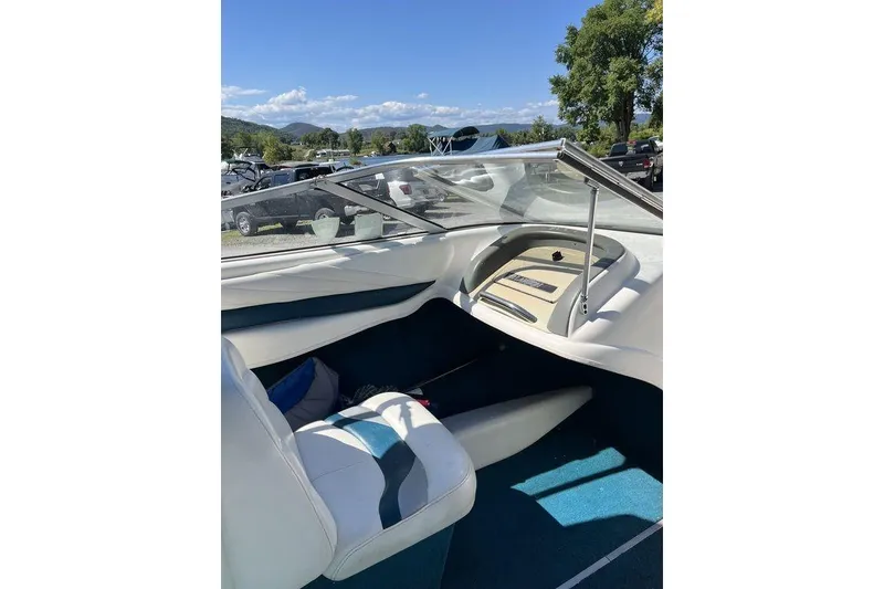 Slide: The Image of Interior view of a 2000 Larson SEI226 boat cockpit with steering wheel and gauges. - 10