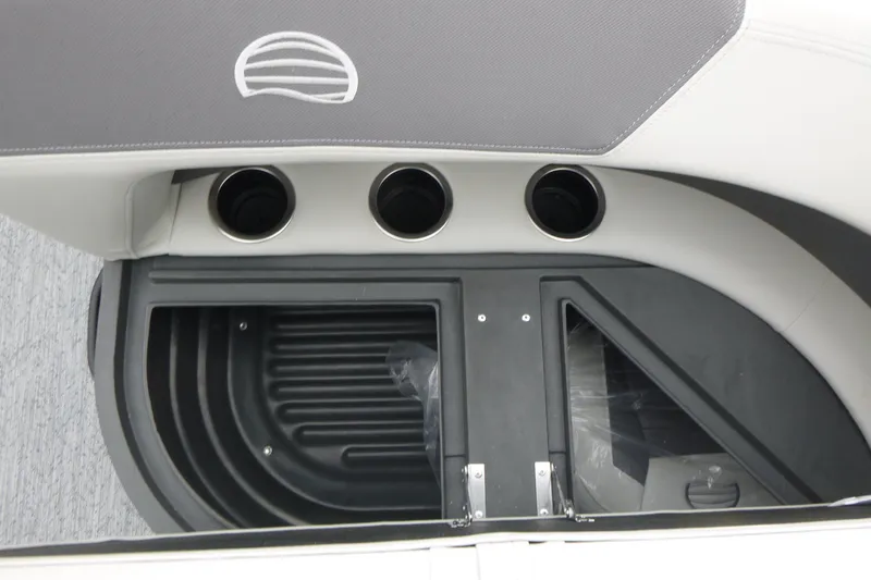 Slide: The Image of 2026 Sun Tracker Bass Buggy 18 DLX interior with cup holders and storage compartment. - 11