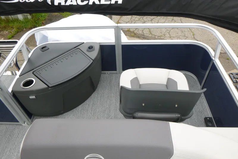 Slide: The Image of 2026 Sun Tracker Bass Buggy 18 DLX interior with seating and storage compartment. - 12