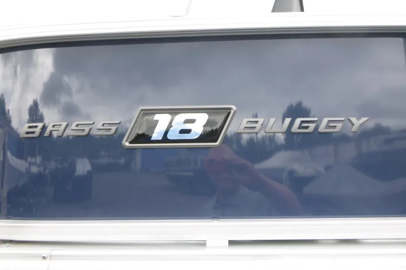 Slide: The Image of 2026 Sun Tracker Bass Buggy 18 DLX logo on a reflective surface. - 14
