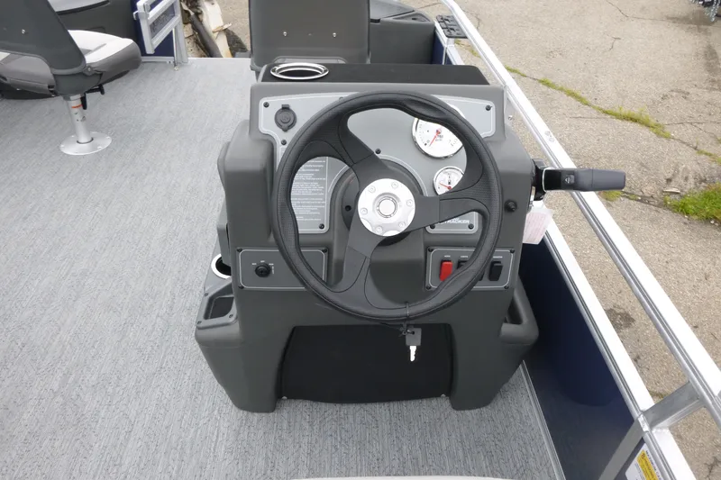 Slide: The Image of 2026 Sun Tracker Bass Buggy 18 DLX steering console with gauges and controls. - 7