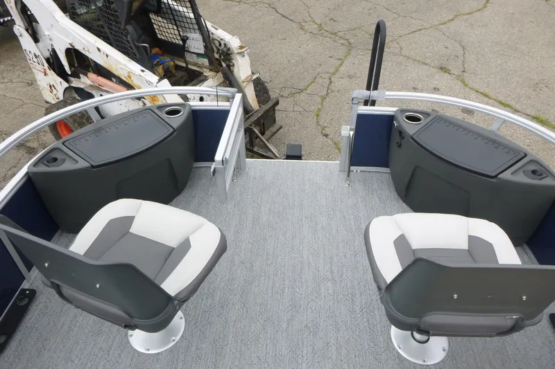 Slide: The Image of 2026 Sun Tracker Bass Buggy 18 DLX pontoon boat with dual swivel seats and storage compartments. - 8