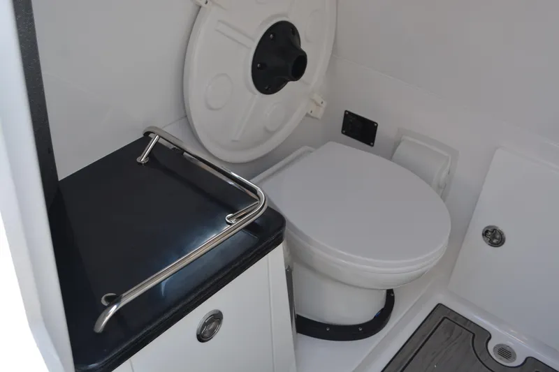 Slide: The Image of 2026 Monterey Elite 30 OB boat bathroom with modern toilet and sleek design. - 15