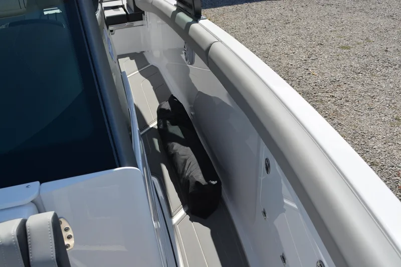 Slide: The Image of 2026 Monterey Elite 30 OB boat interior with seating and storage area. - 16