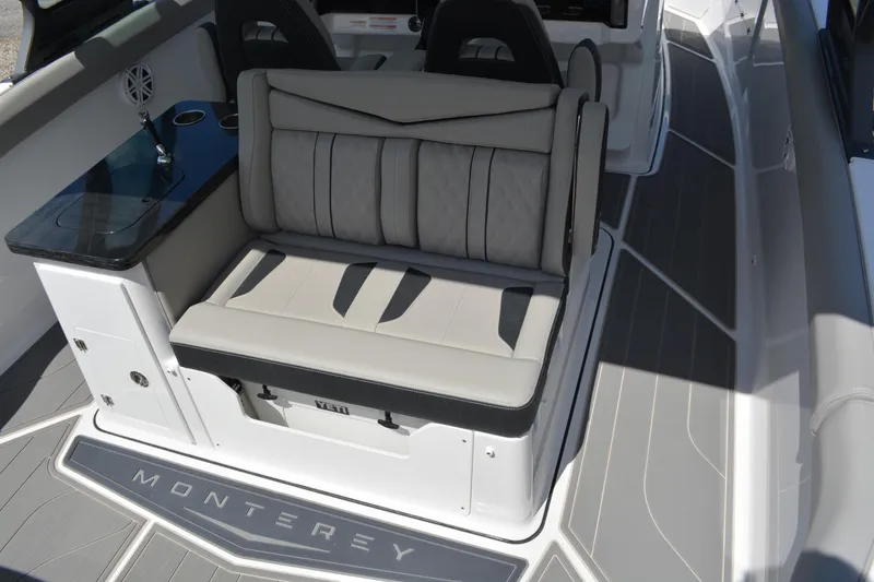 Slide: The Image of 2026 Monterey Elite 30 OB boat interior with cushioned seating and sleek design. - 19