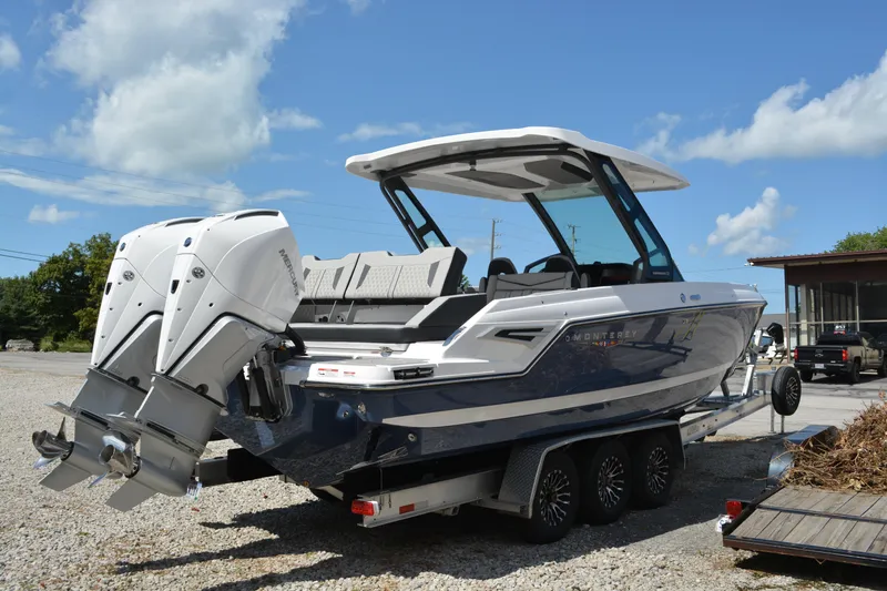 Slide: The Image of 2026 Monterey Elite 30 OB boat with dual outboard engines on a trailer. - 5